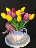 Spring mini tulips in water pitcher